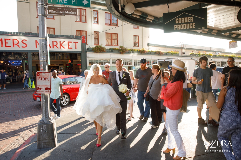 bride_and_groom_walk_through_pike_place_market