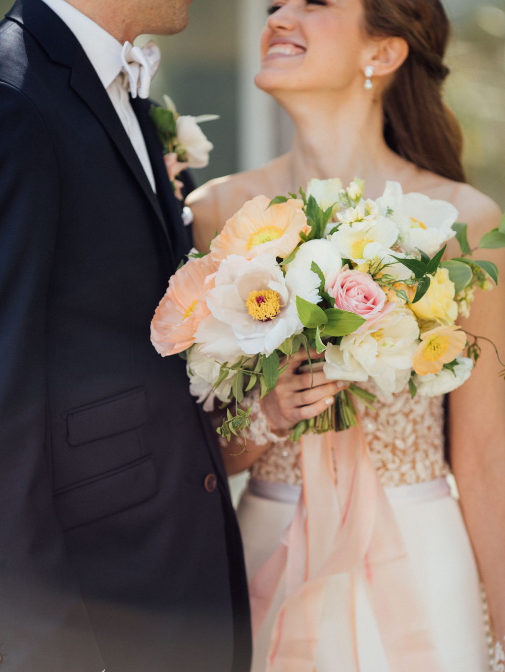 close-up-of-bride-holding-white-pink-and-yellow-bouquet