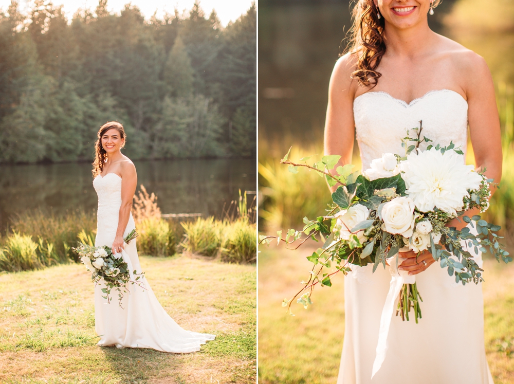 bride-holds-white-bouquet-by-lake