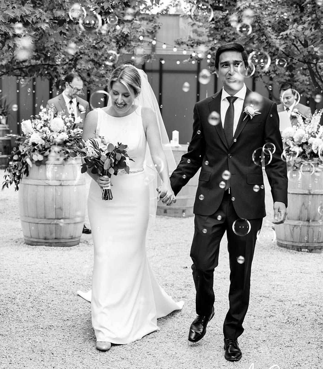 Bride and groom walking a bubble filled recessional - Pink Blossom Events