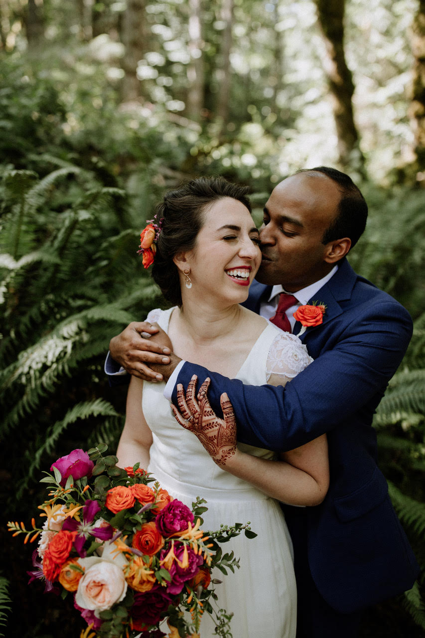 Happy bride and groom in a PNW forest - Pink Blossom Events