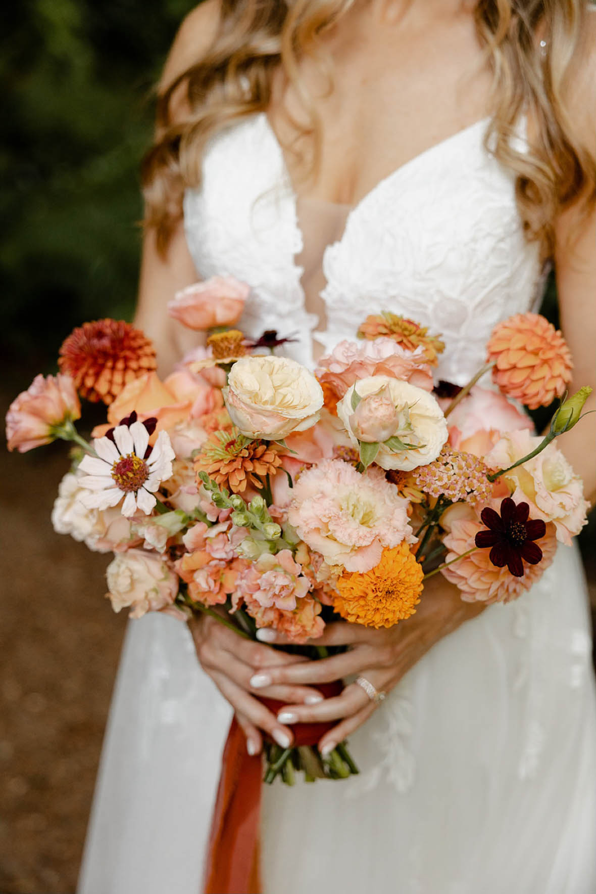 Peach and orange wedding bouquet from a summer wedding at JM Cellars planned by Pink Blossom Events