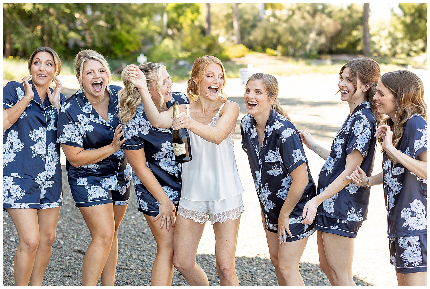 bride and bridesmaids popping Champagne 